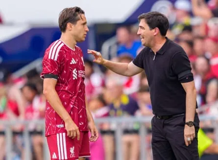 Liverpool head coach Andoni Iraola speaks with Federico Chiesa on the touchline